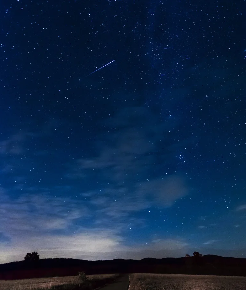 A meteor photographed burning up in the atmosphere — dust grains, not the stars the Qur'an calls lamps