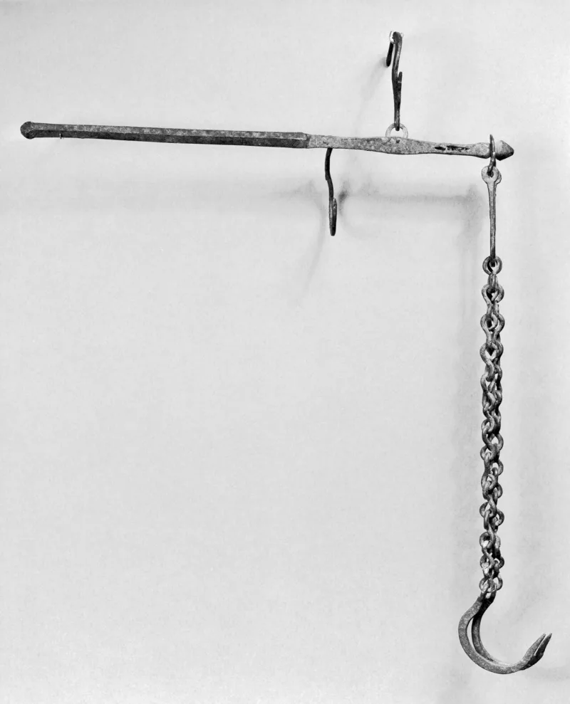 A Byzantine steelyard balance — a period weighing instrument, standing in for the scales described