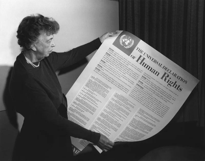 Eleanor Roosevelt holding a poster of the Universal Declaration of Human Rights, 1949
