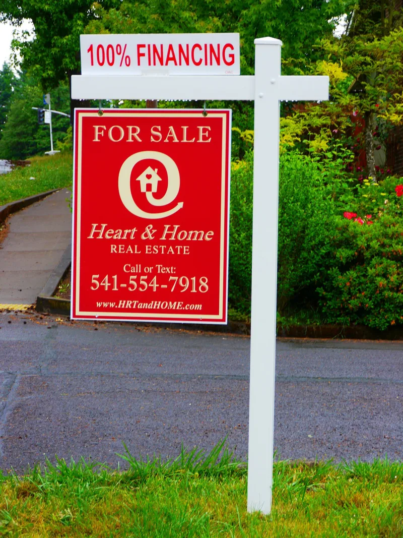 A modern estate agent's sign; a representative image, not a house sold by any Witness for 1975
