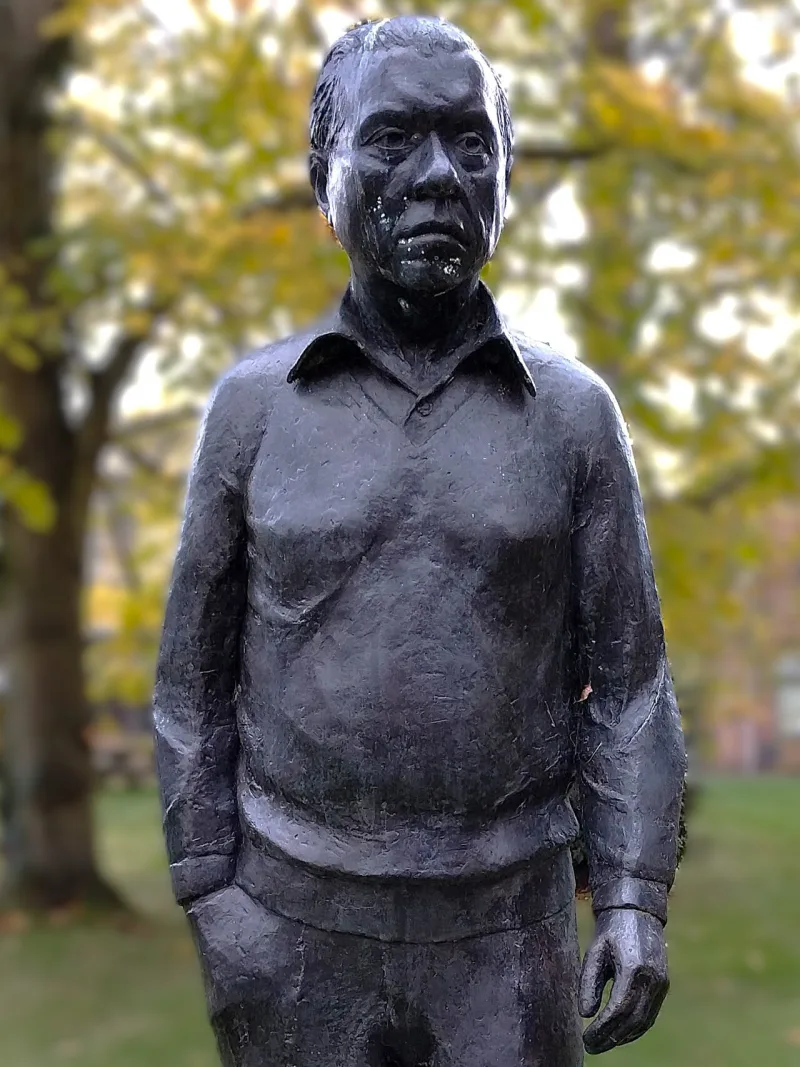 The statue of Fred Hoyle at Cambridge; his carbon resonance work gave the best-known fine-tuning example