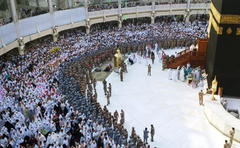 Inside the Kaaba during its ceremonial washing; the building is empty, and prayer faces it, not an image