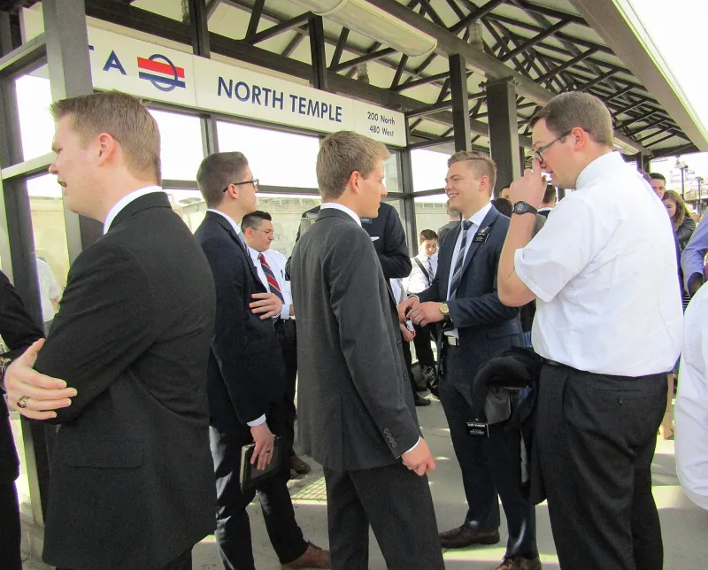 Latter-day Saint missionaries at a train station, serving the full-time assignment that members fund themselves