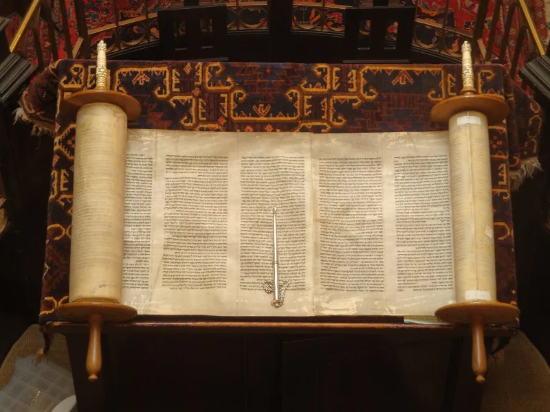 A Torah scroll and pointer; the letter sequence that code-hunters run their skip searches over
