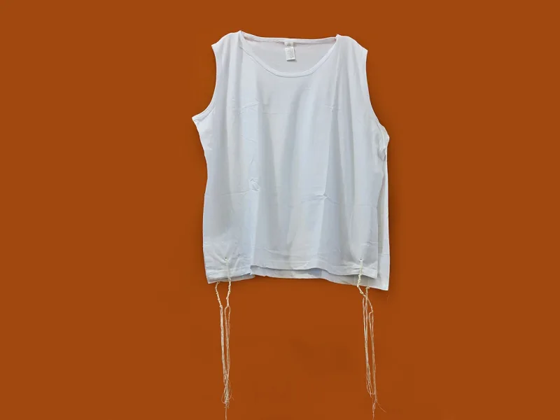 A tallit katan with its knotted fringes, the tzitzit commanded in Numbers 15:38